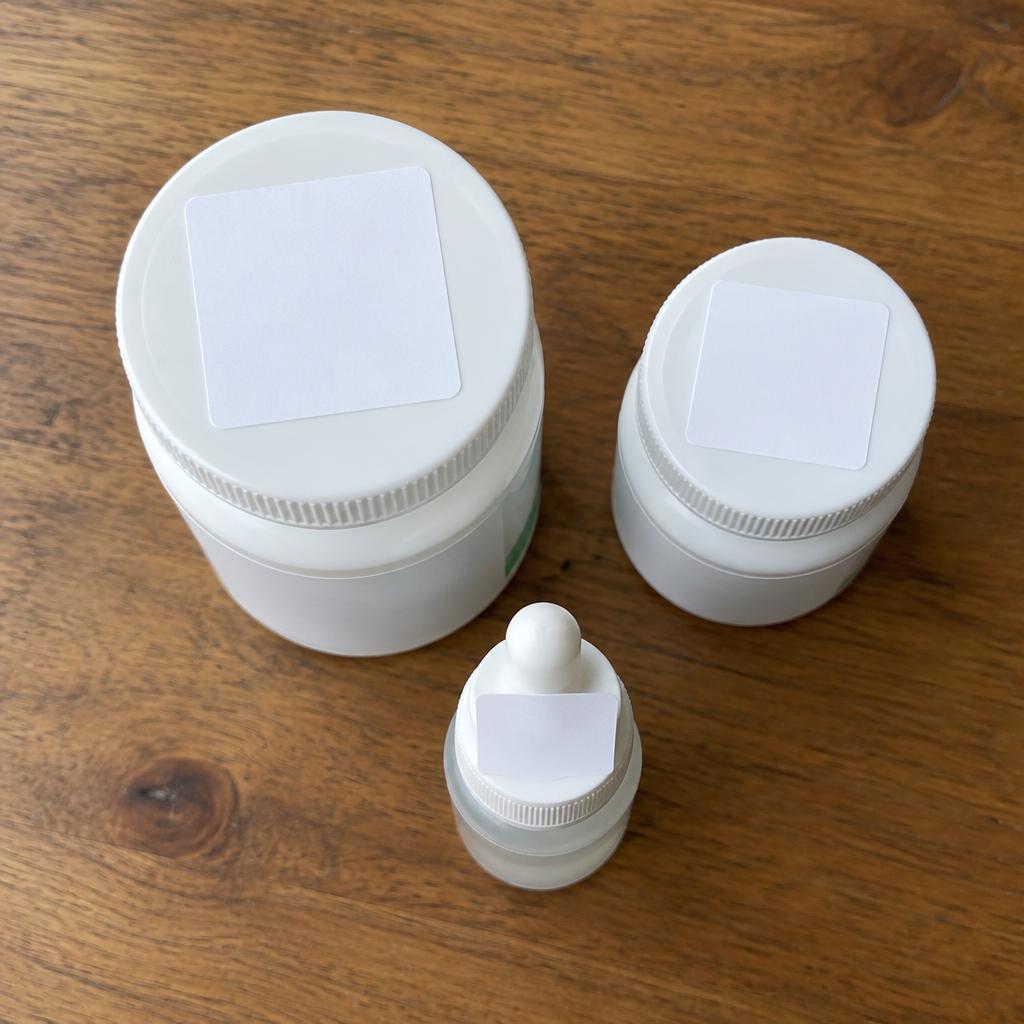 Placeholder photo of medication containers with square lid labels